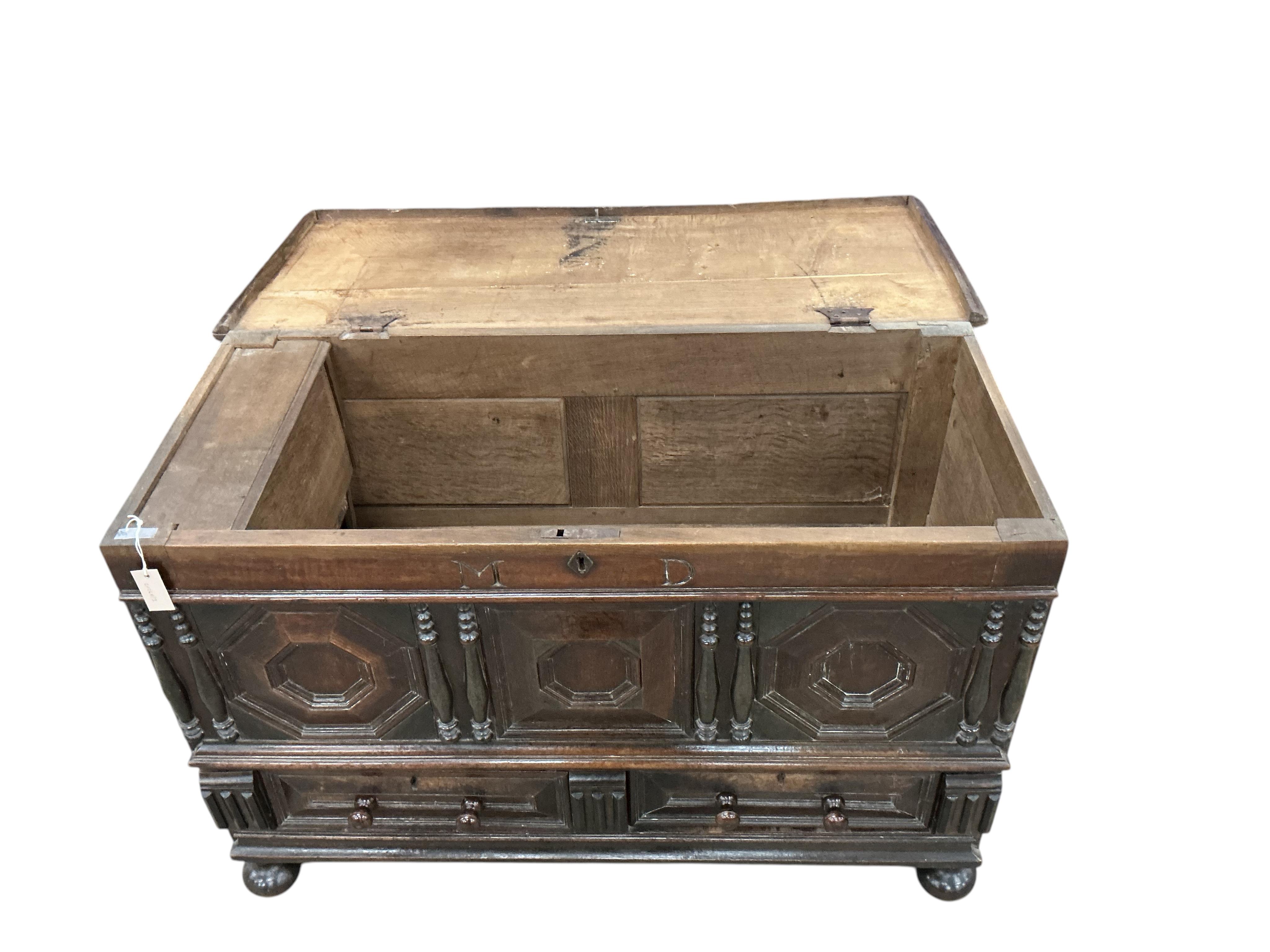 An 18th century panelled oak mule chest, carved with the initials M D, width 129cm, depth 57cm, height 83cm